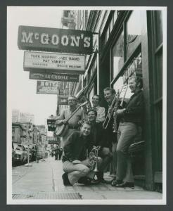 Publicity photograph of Turk Murphy Jazz Band in front of Earthquake McGoon’s, 630 Clay Street, with Dick Speer, Leon Oakley, Pete Clute, Jim Maihack, Turk Murphy, Phil Howe – circa 1970