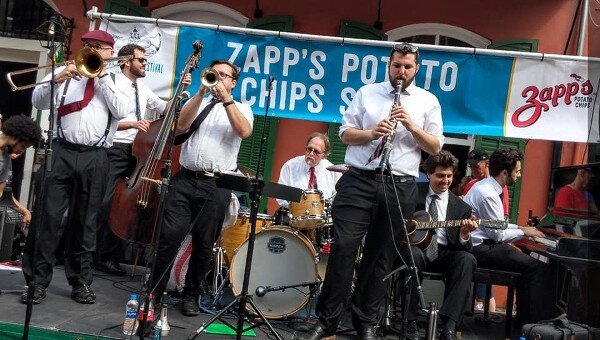 Hal Smith’s On the Levee Jazz Band performs on Bourbon Street at the 2019 French Quarter Festival in New Orleans. From left, Clint Baker, Joshua Gouzy, Ben Polcer, Hal Smith, Joe Goldberg, Alex Belhaj, and Kris Tokarski. Photo by Megan Gouzy; courtesy Hal Smith