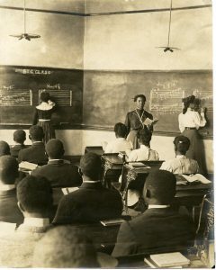 Tuskegee Institute teacher Mrs. Emily Moore Neely teaching her music class, circa (1920) .