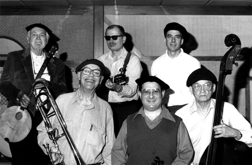 An Oxtot group at the Jack Tar Hotel, San Francisco, 2.16.97. L to R, front row: Bill Bardin (trombone), Ray Landsberg (violin), Jim Cumming (bass); back row Dick Oxtot (banjola), B. Wilson (guitar) and Hugh O’Donnell (drums). Photo by Ed Lawless.