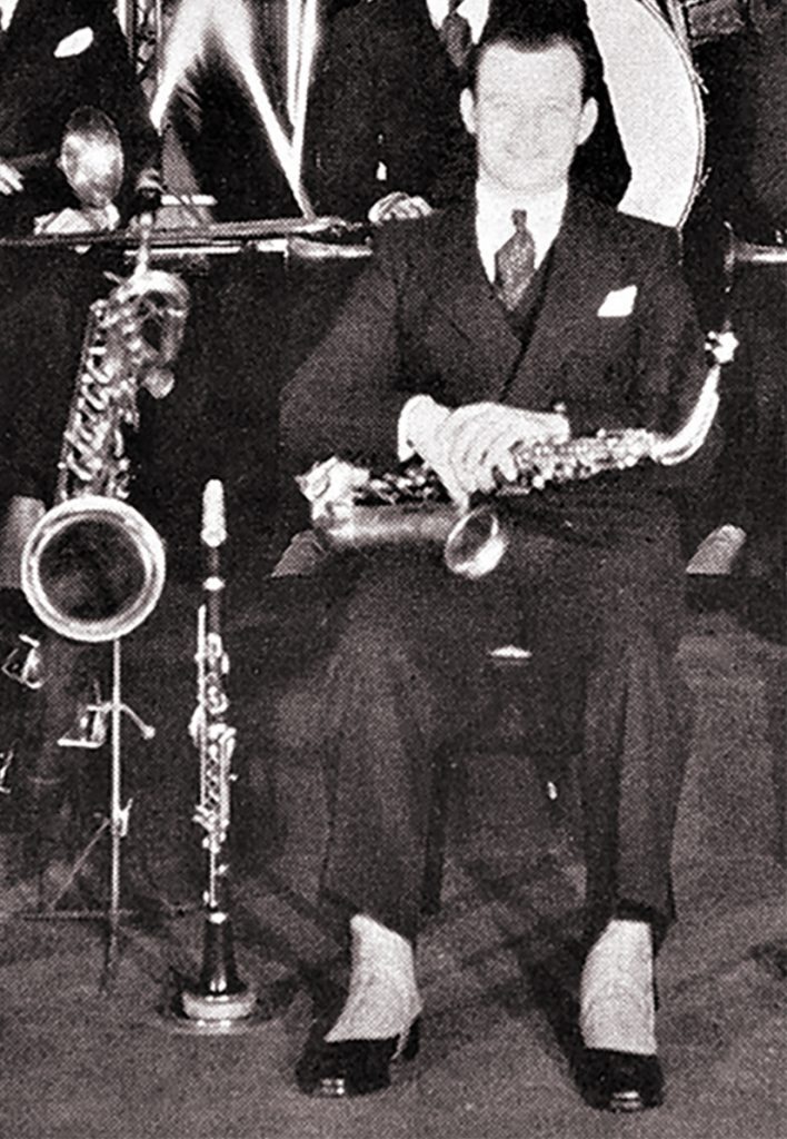 Clarence Hutchenrider with baritone sax, clarinet, alto sax and spats, 1930.